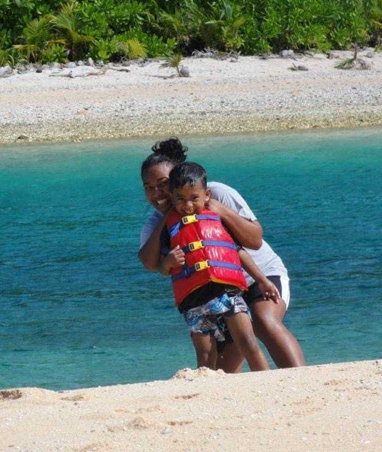 Little Skylar with his sister Deatra Lehsi as part of his first visit to Pingelap. 