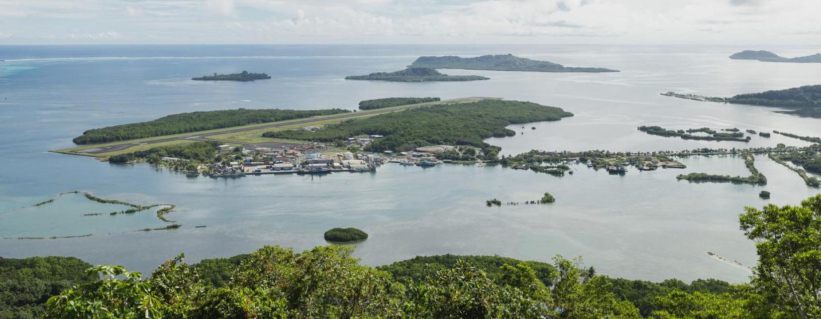 Visual of the Pohnpei airport from above, it is a strip of land surrounded by ocean.